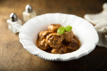 Homemade meatballs in a white bowl