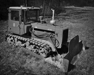 Fototapeta na wymiar A bulldozer on caterpillars during a break at work.