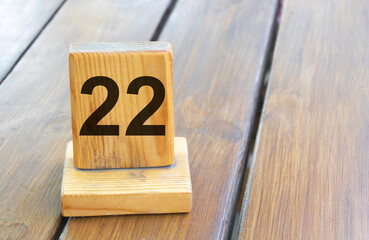 Wooden priority number 22 on a plank tab