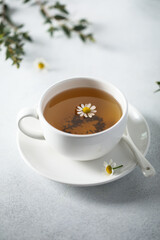 Healthy homemade chamomile tea in a white cup