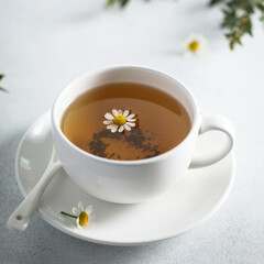 Healthy homemade chamomile tea in a white cup
