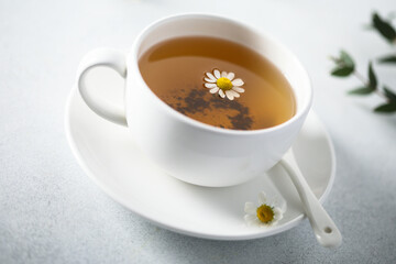Healthy homemade chamomile tea in a white cup