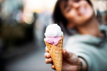 Beautiful young brunette woman having a refreshing ice cream. Food. Ice cream. Happy day. Smile. 