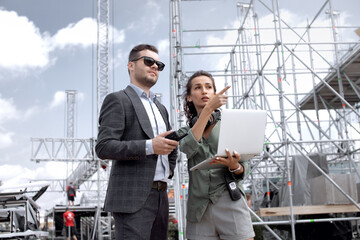 Event managers discuss stage construction. Installation of stage equipment and preparing for a live...