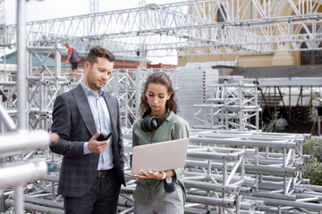 Event managers discuss stage construction. Installation of stage equipment and preparing for a live...