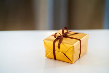 A small gift, packed in a golden wrapper.