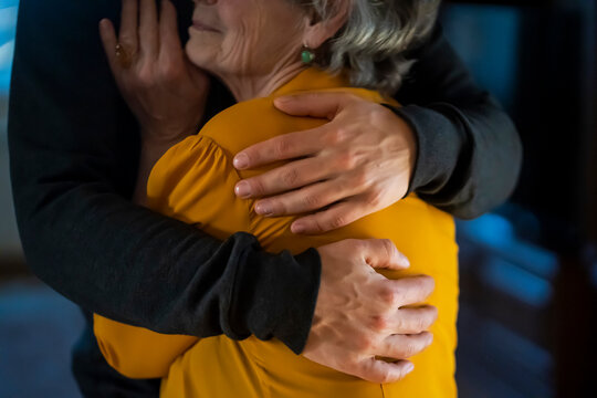 Man support his old grandmother, holds her hands.