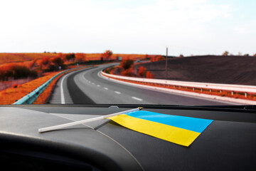 Ukrainian flag on glass inside the car