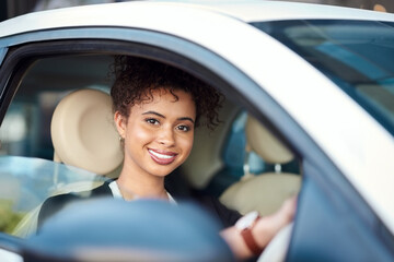 Feels good being on this side of the car. Cropped portrait of an attractive young businesswoman smiling while driving her new car.