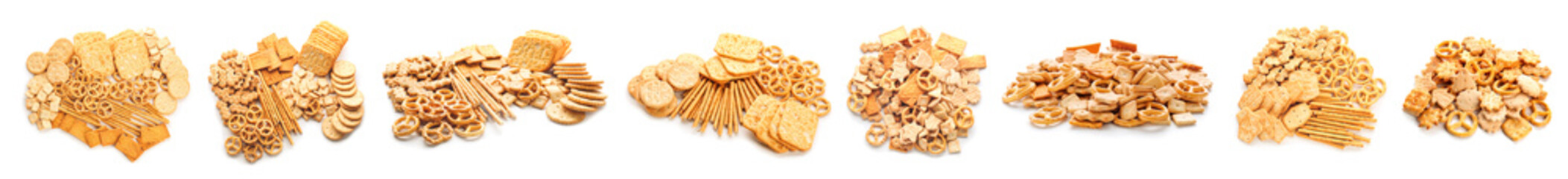 Tasty different crackers on white background