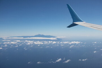 Fototapeta na wymiar Wing airplane above Atlantic Ocean with view at Tenerife