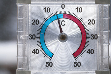 Outdoor window thermometer shows negative temperature in degrees Celsius