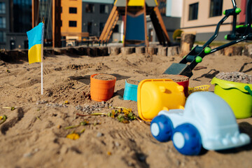 toys in the sand at the playground. Ukraine flag