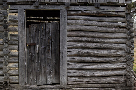 Old wooden rustic doors on rural home wall.