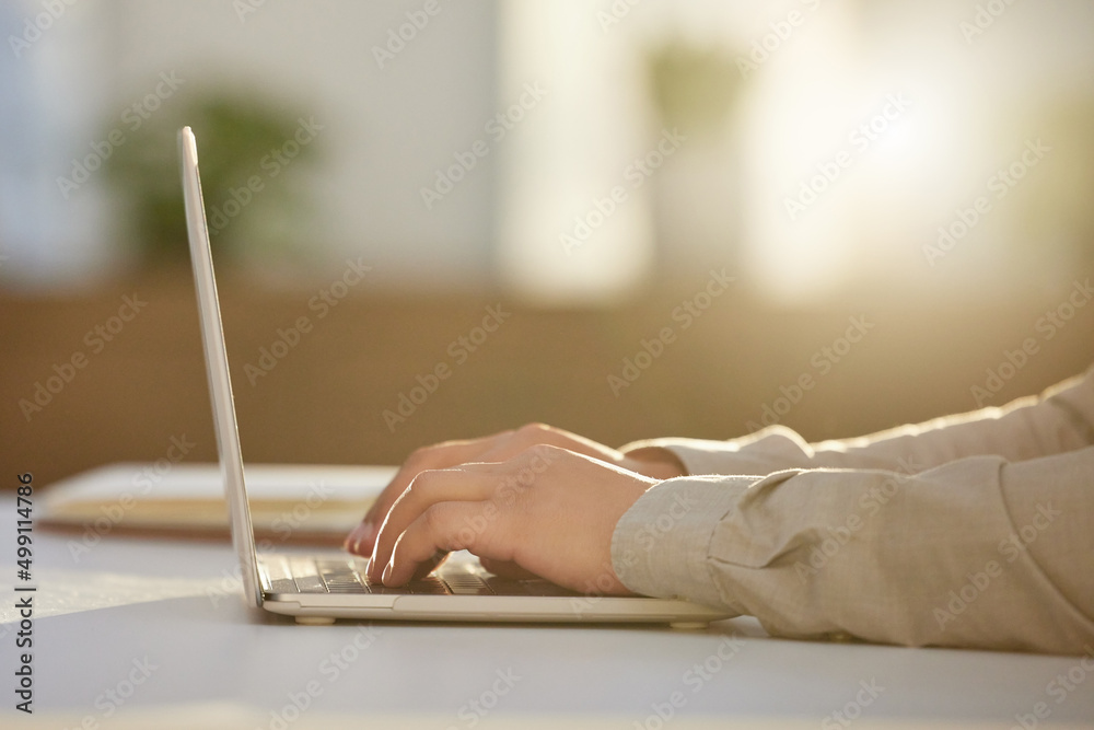 Poster drafting client emails. cropped shot of an unrecognizable businessman sitting alone in the office an