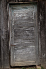 Old wooden rustic doors on rural home wall.