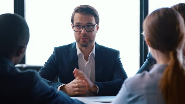 A group of people at a business meeting in the office against the window