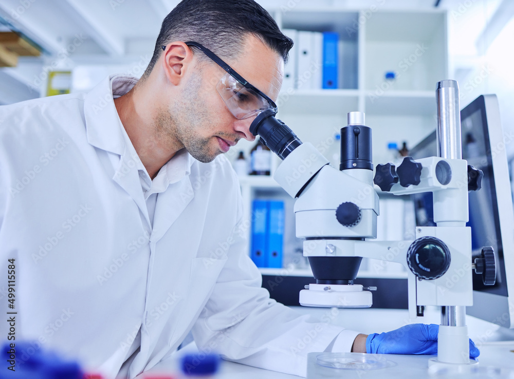 Aufkleber running a few tests. cropped shot of a handsome young male scientist working with a microscope in hi