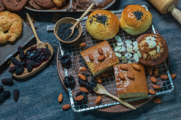 Round toasted bread and banana cakes are placed on a stainless steel baking rack.