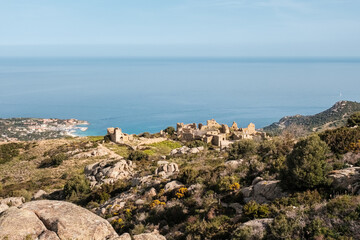 Fototapeta na wymiar The abandoned village of Occi near Lumio in the Balagne region of Corsica with Mediterranean sea in the distance