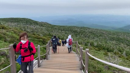 제주도 한라산 성판악 코스, 등산복과 등산 스틱을 가지고 등산하는 여자, 계단, 풍경 / Mt. Halla Seongpanak Course in Jeju Island, women hiking with hiking clothes and hiking sticks, stairs, scenery  - Powered by Adobe