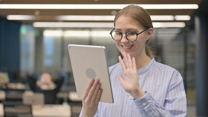 Online Video hat via Tablet by Woman