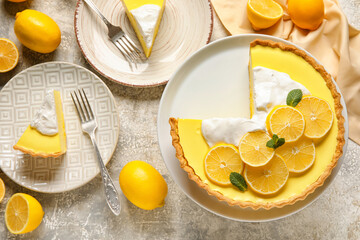 Stand and plates with tasty baked lemon pie on light background