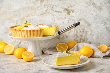 Plate with piece of tasty lemon pie and fresh fruits on light background