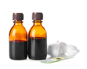Bottles with iodine, medical plaster and cotton balls on white background