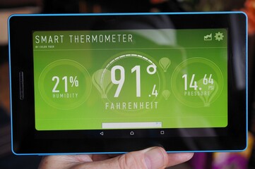 hand holding tablet pc with temperature app
