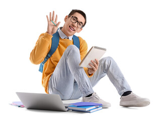 Male Asian student with notebook waving hand on white background
