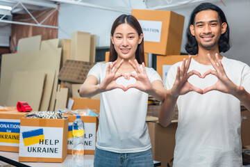 Group of volunteers  asian  man and asian woman preparing food donations for people in need in...