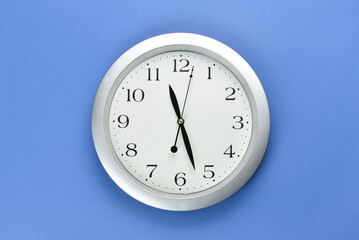 New modern clock on blue background