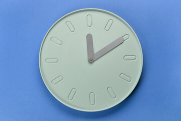 New modern clock on blue background