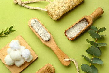 Set of bath supplies with eucalyptus branches on green background