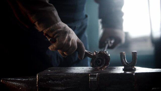Blacksmith workshop - a man shaping rose leaves out of heated metal