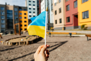 woman holding flag of ukraine on the street