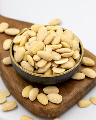 Peeled almond kernel isolated on white background. A bowl of almonds. close up