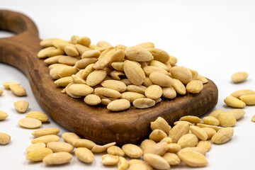 Peeled almond kernel isolated on white background. A bowl of almonds. close up
