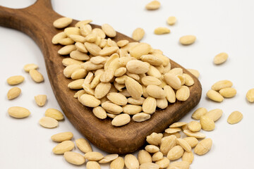 Peeled almond kernel isolated on white background. A bowl of almonds. close up