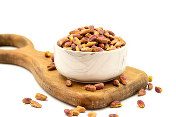 Pistachio kernel isolated on white background. A bowl of pistachios. close up