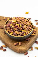 Pistachio kernel isolated on white background. A bowl of pistachios. close up