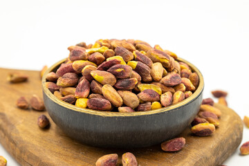 Pistachio kernel isolated on white background. A bowl of pistachios. close up