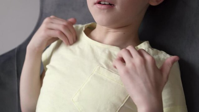 Boy practicing EFT or emotional freedom technique - tapping on the collarbone point