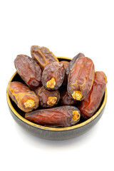 Date fruit isolated on a white background. A bowl of date fruit (Medjoul). close up