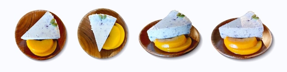 Piece of delicious blueberry cheesecake and fruit peach on wood plate. Isolated white background. Different angle - top view side view perspective