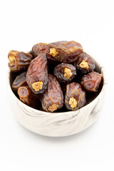 Date fruit isolated on a white background. A bowl of date fruit (Medjoul). close up