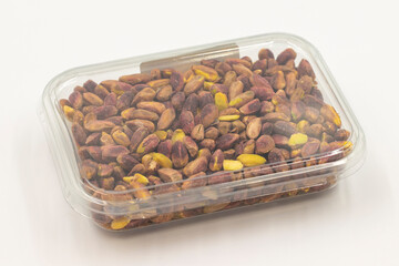 Packed pistachios on a white background. Pistachios packaged for sale at the market counter. close up