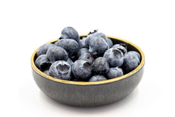 Blueberry isolated on white background. Blueberries in the bowl. Close-up.