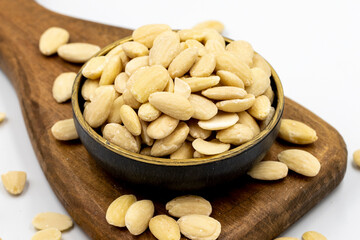 Peeled almond kernel isolated on white background. A bowl of almonds. close up